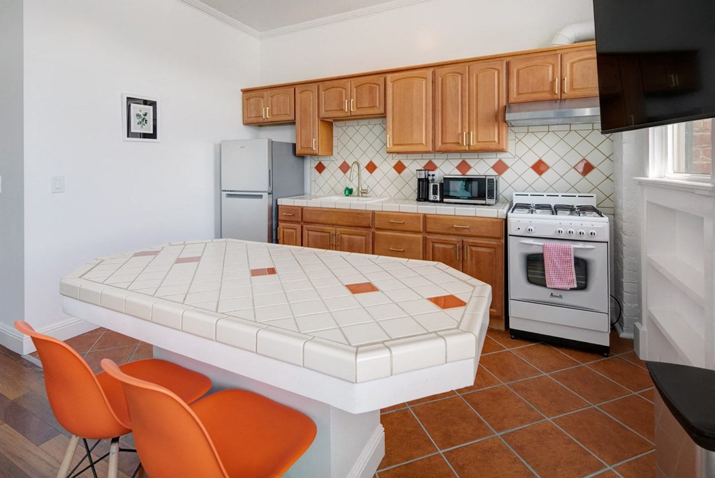 a kitchen with a white table and chairs and a stove