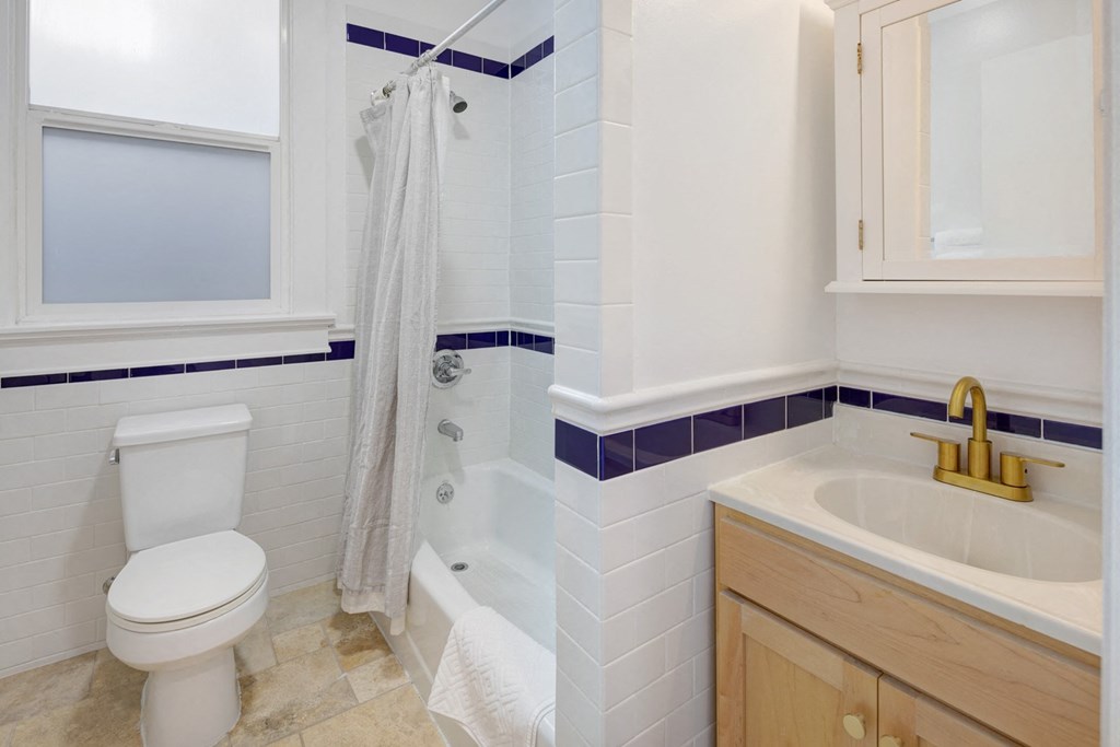 a bathroom with a toilet and a sink and a shower