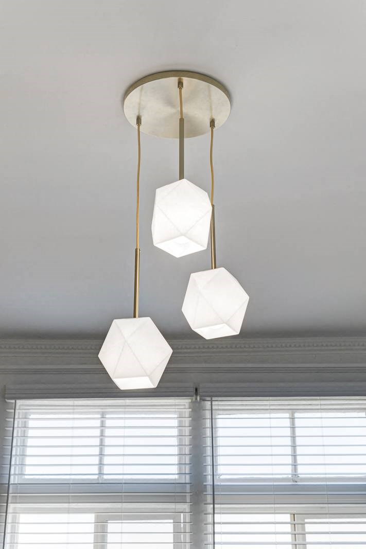 a trio of hanging lights in a room with a white ceiling