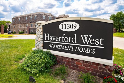 A sign for Haverford West Apartment Homes in front of a building.