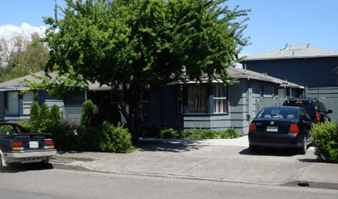A car is parked in front of a house.
