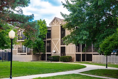 A building with a white fence in front of it.