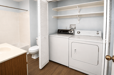 A white laundry room with a washer and dryer.