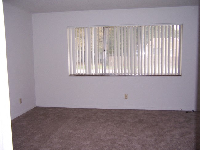 an empty living room with a large window