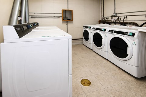 A white dryer and washing machine in a laundry room.