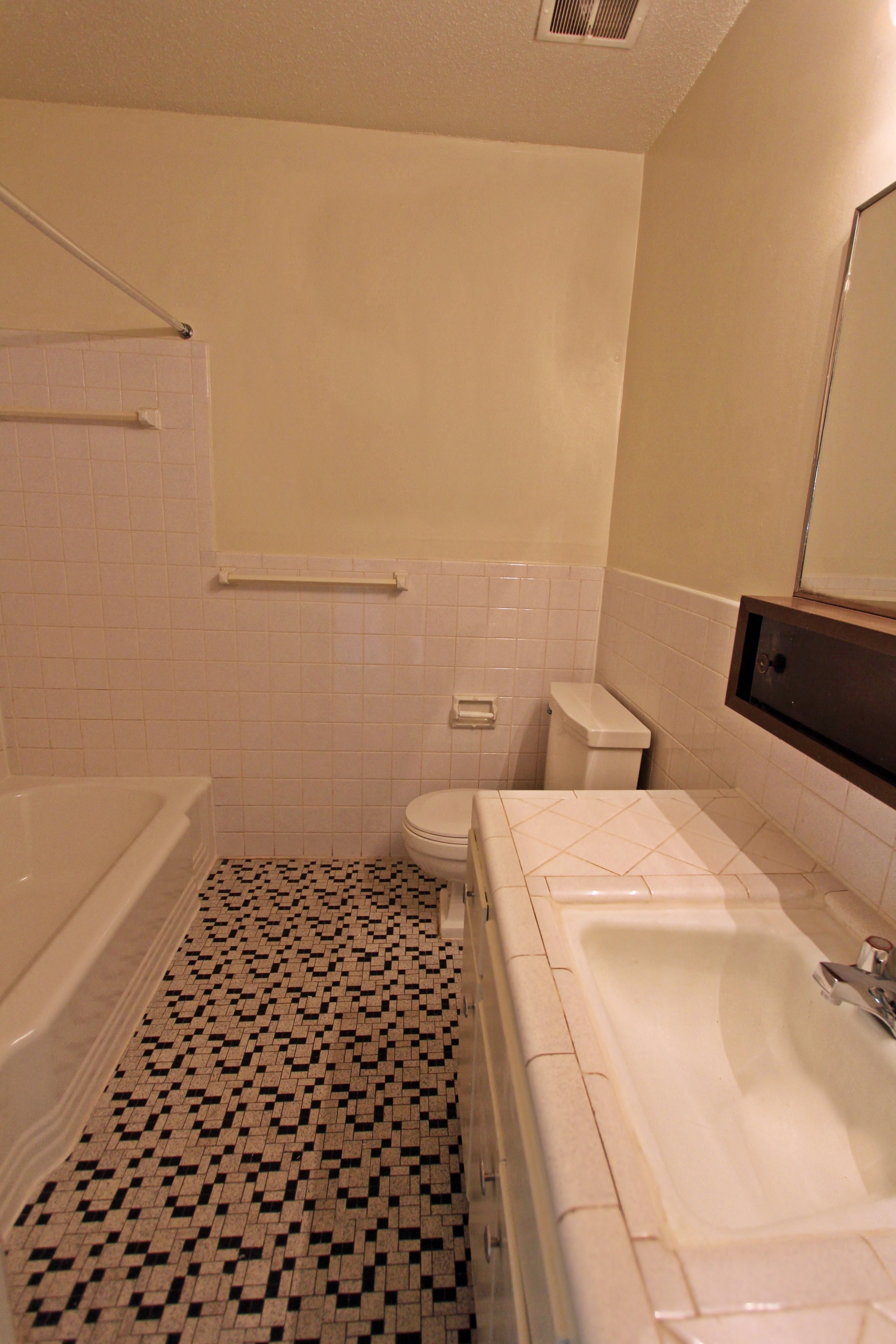 a bathroom with a sink toilet and a bath tub