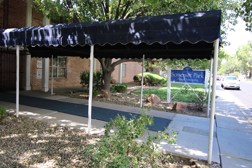 a blue awning in front of a brick building