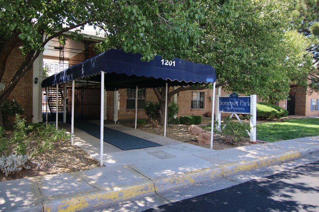 a blue awning in front of a brick building