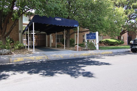 a building with a blue awning in front of a street