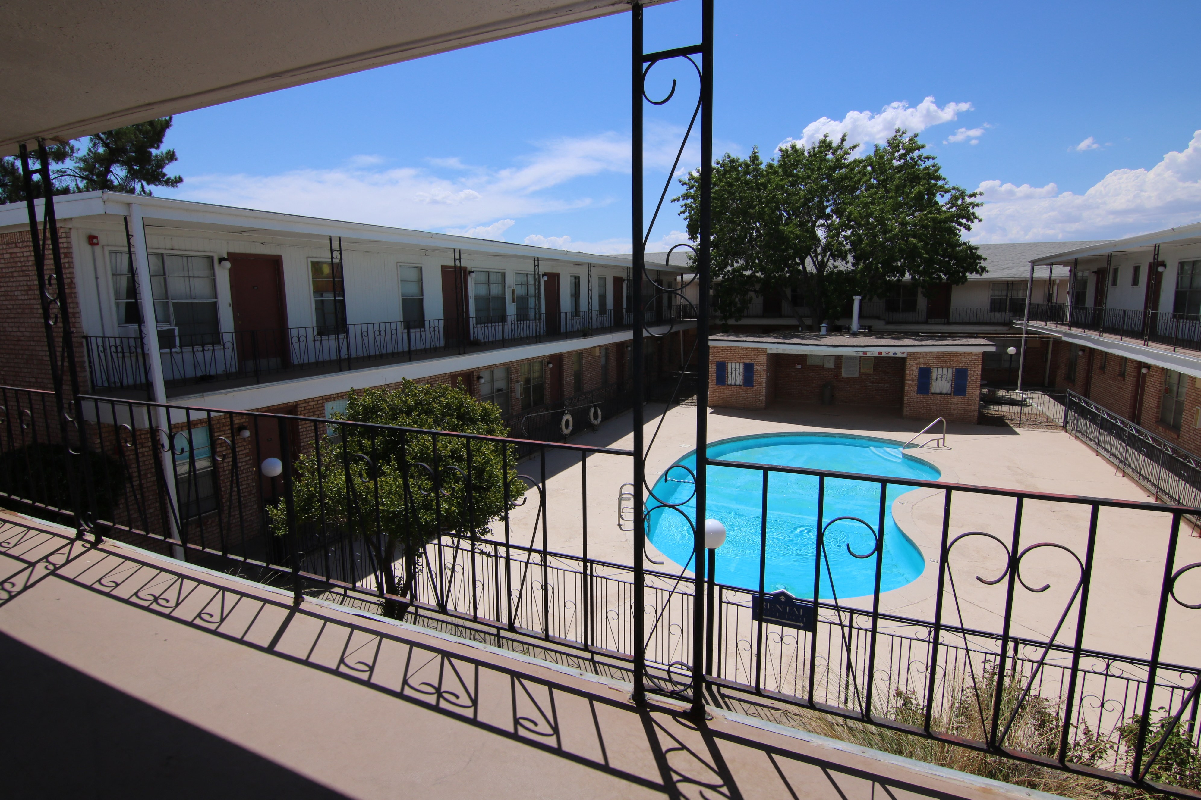 a view of the pool from the balcony of an apartment building