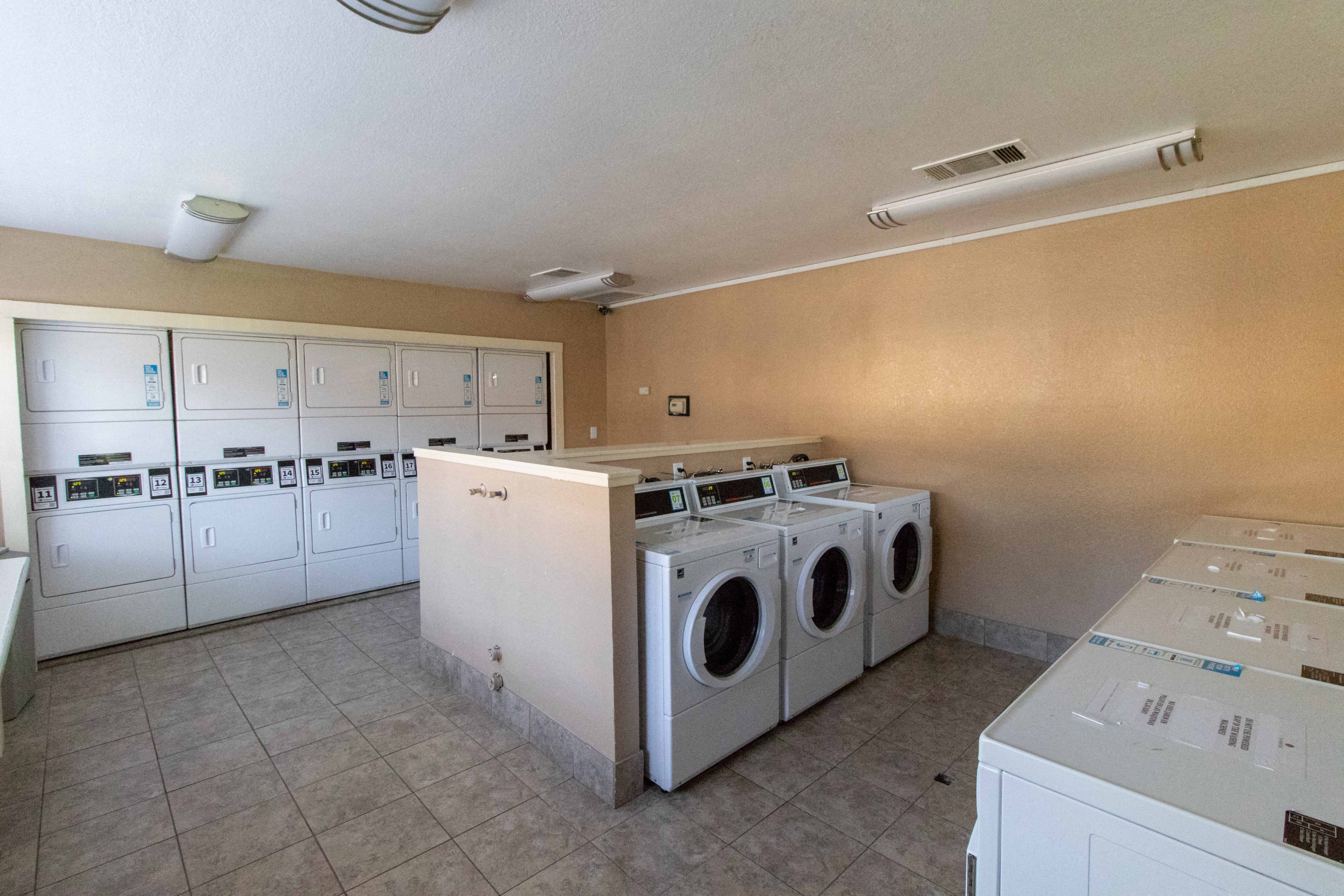 a laundry room with washes and dryers in it