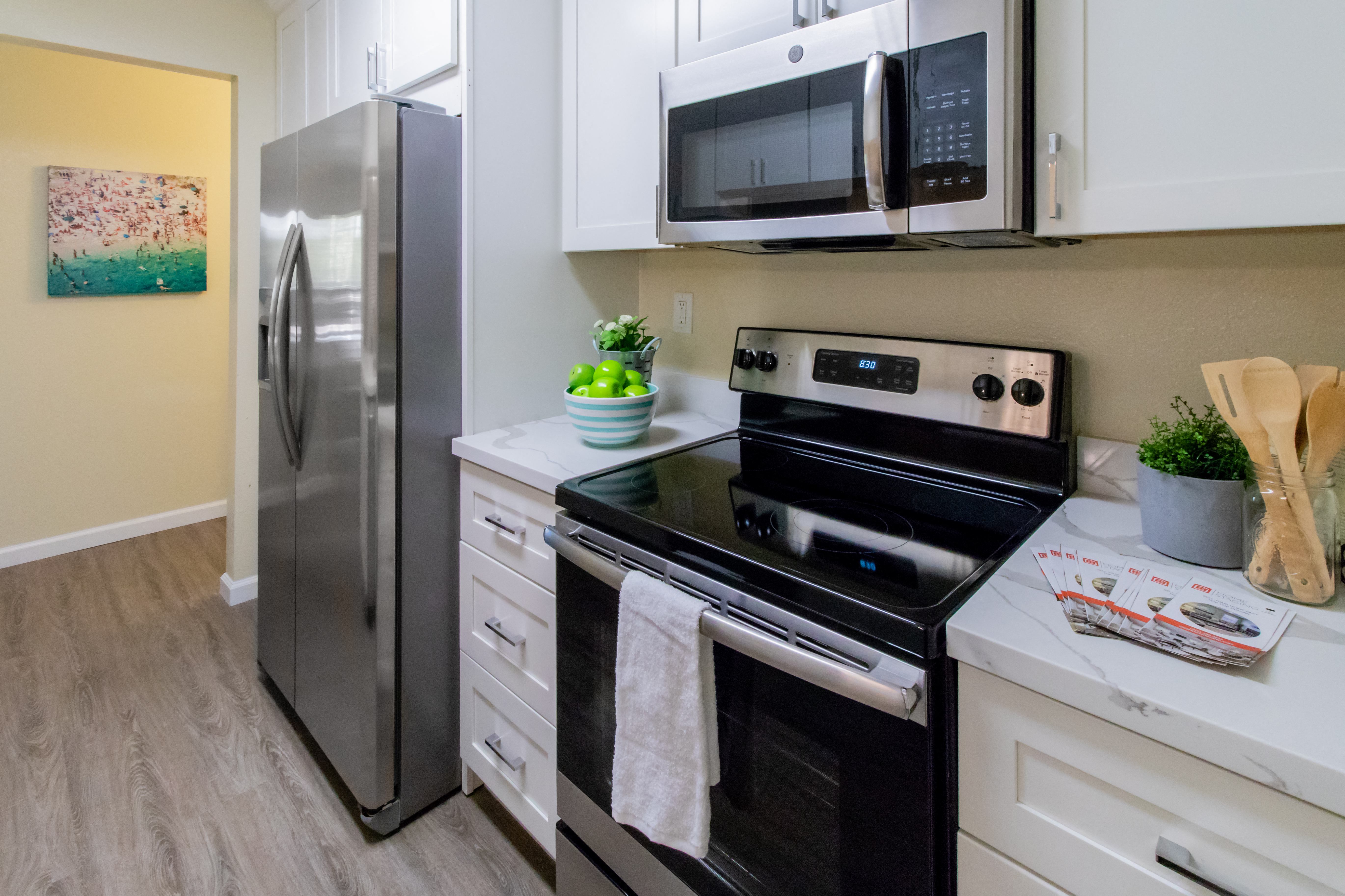 a kitchen with stainless steel appliances and white cabinets