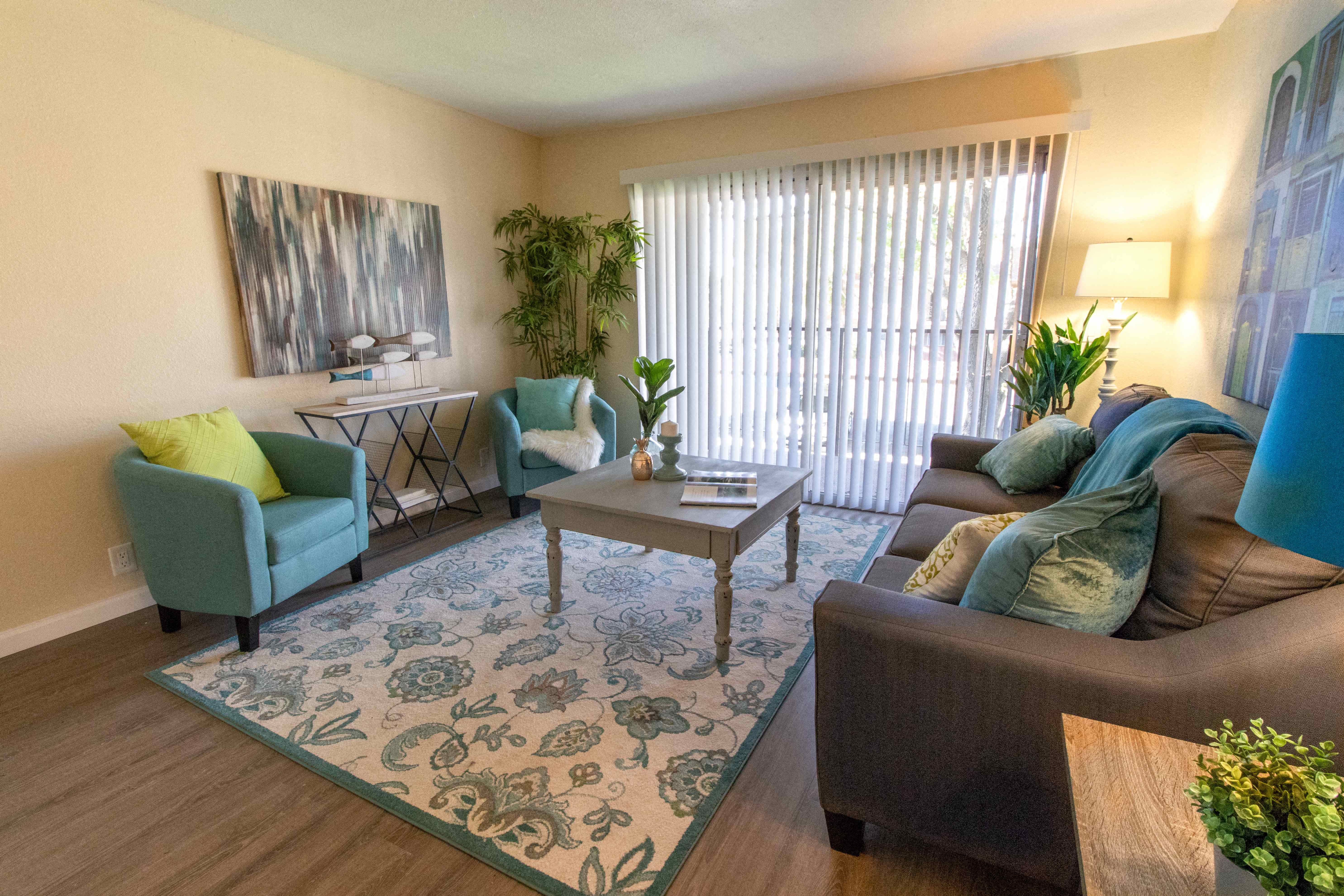 a living room with a couch and chairs and a rug