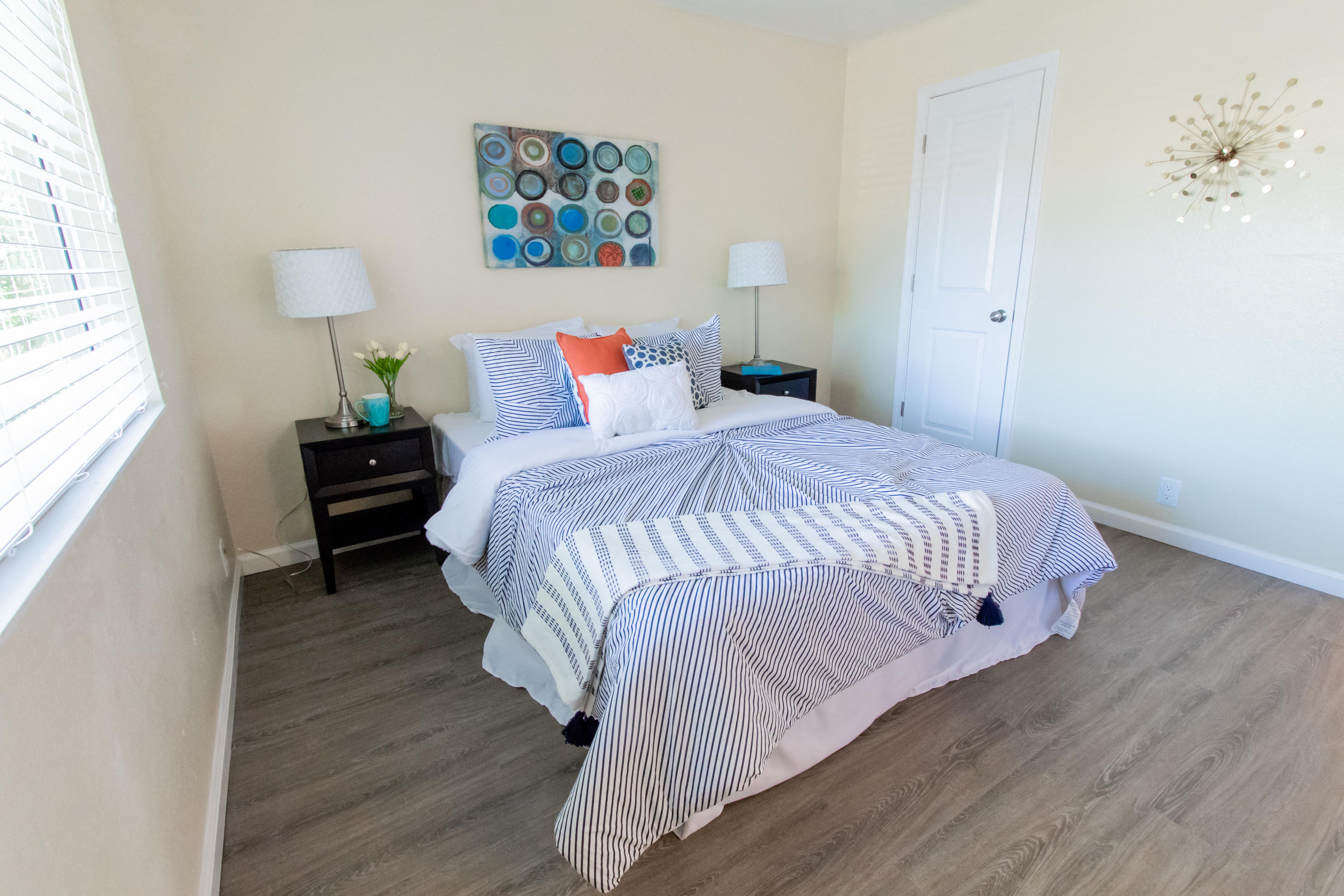 a bedroom with a bed and a window