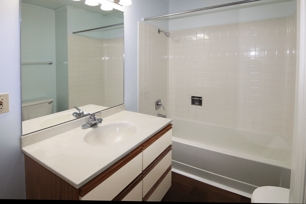 A white sink with a silver faucet in a bathroom.