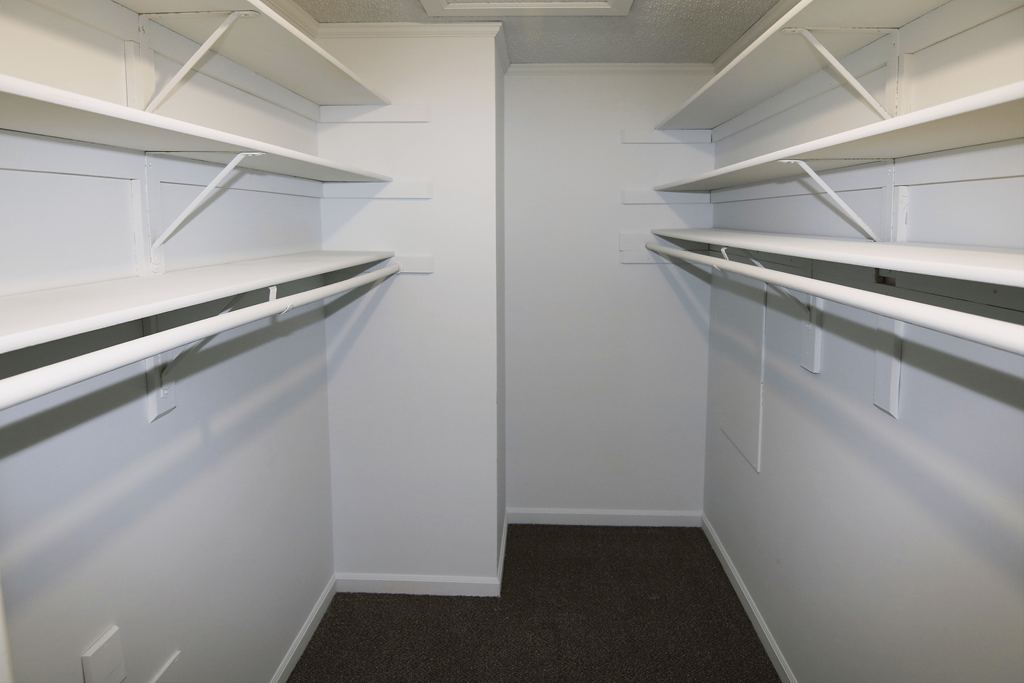 Empty white shelves in a room.