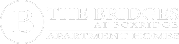 The image is of a logo for The Bridges at Foxridge Apartment Homes.