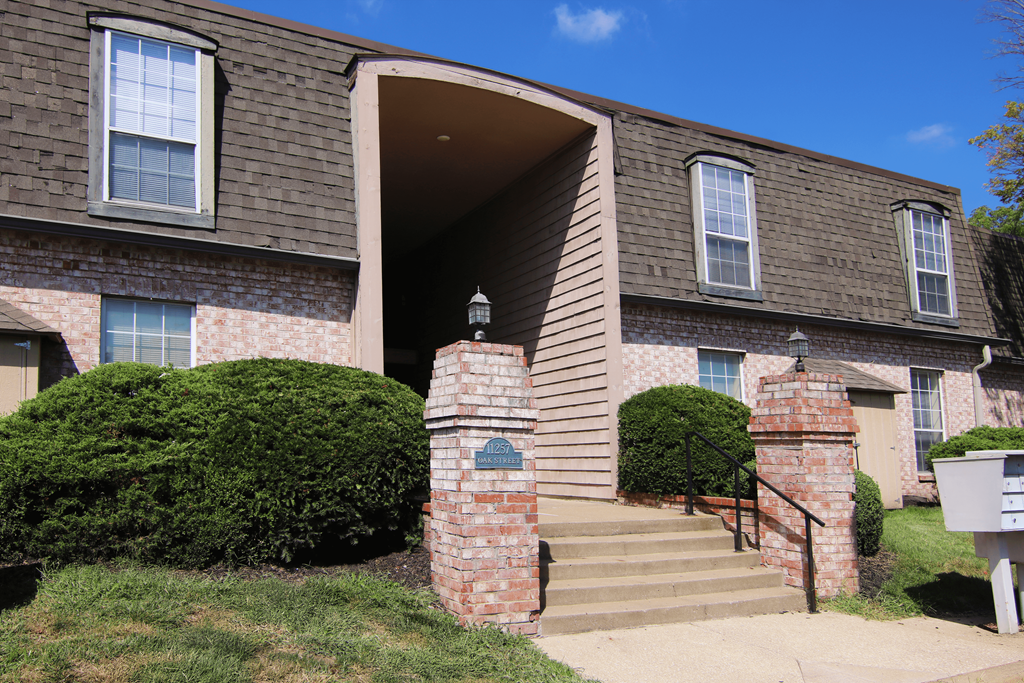 A house with a brown roof and a white mailbox.