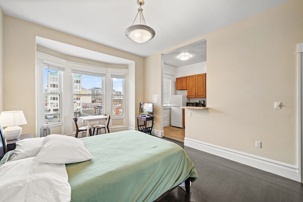 a bedroom with a bed and a large window