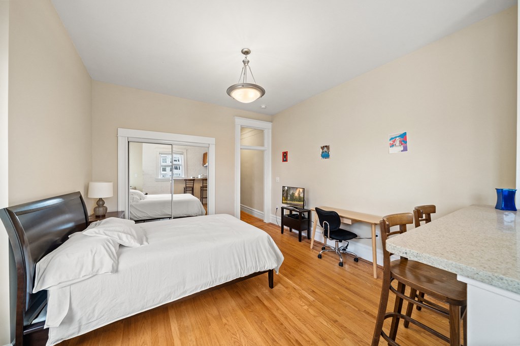 a bedroom with a bed and a desk with a chair