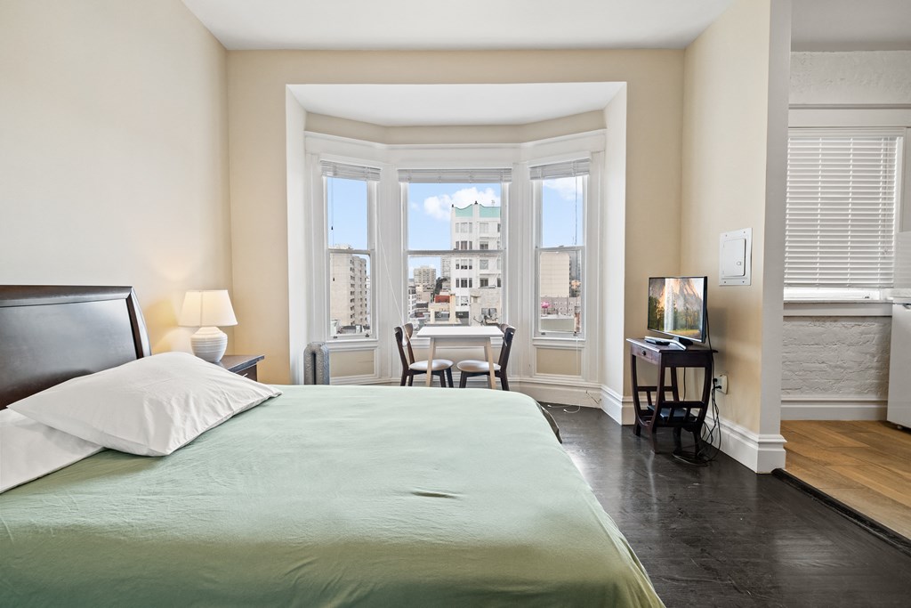 a bedroom with a large bed and a window