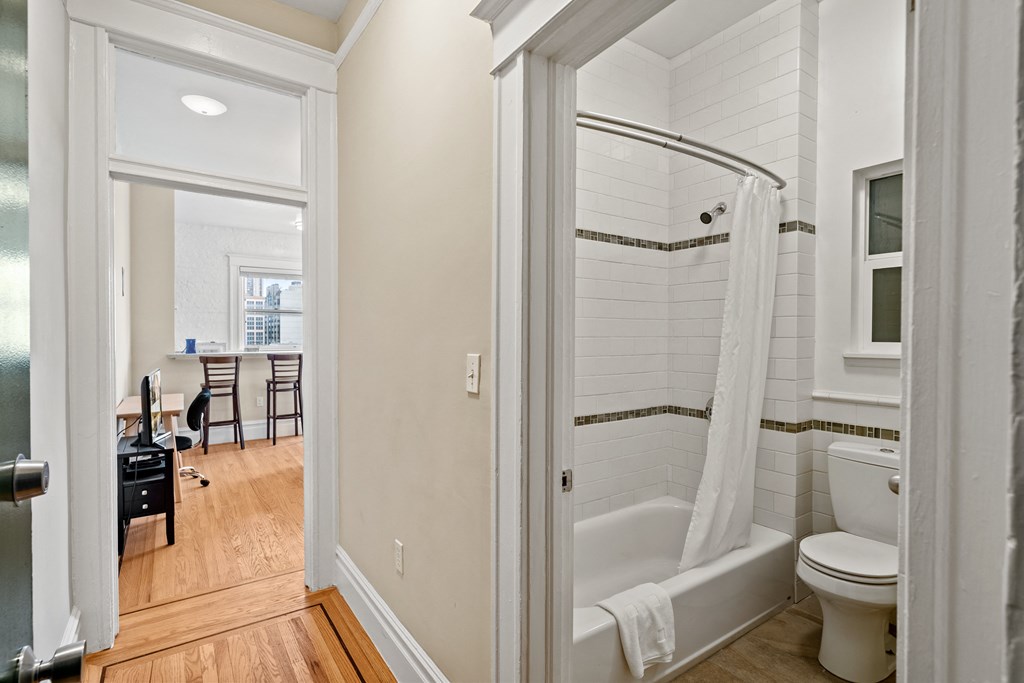 a bathroom with a shower and a toilet and a sink