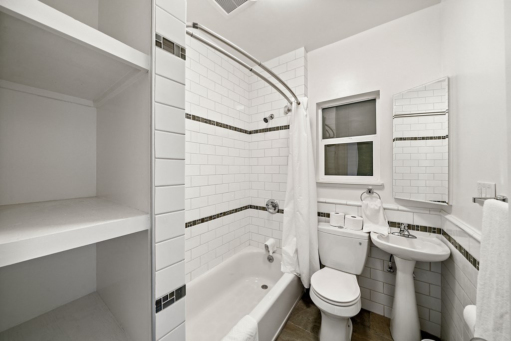 a small bathroom with a toilet sink and tub