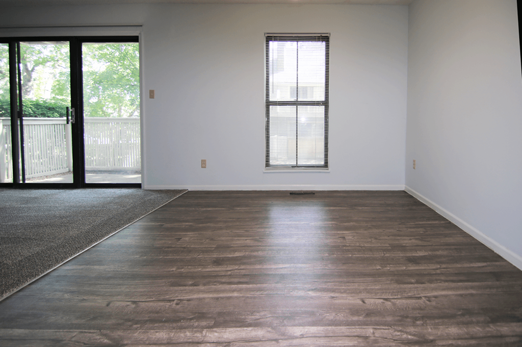 A room with a window and sliding glass doors.
