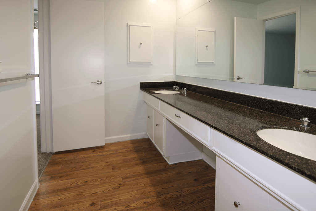 A bathroom with a white sink and a white door.
