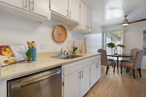 Kitchen Sink, Dishwasher, and Dining Room at Three Crown Apartments, Alameda, CA, California, 94501