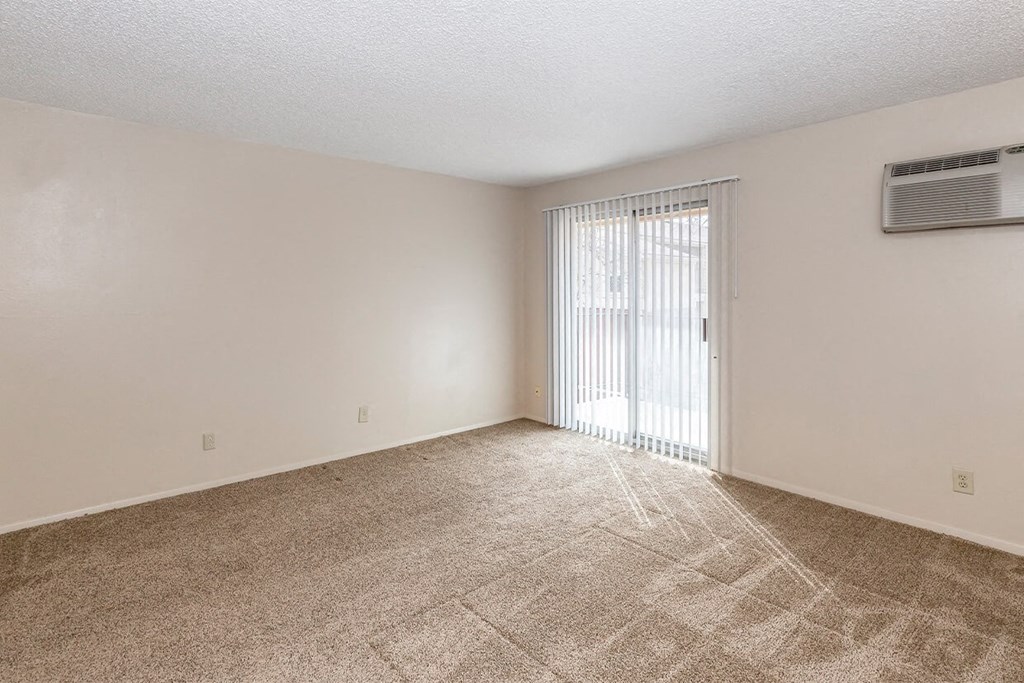 Studio Living Space and Balcony Door at Raintree Apartments, Topeka, KS, 66614