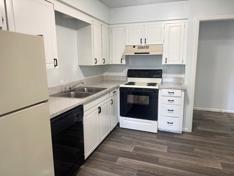 A kitchen with white cabinets