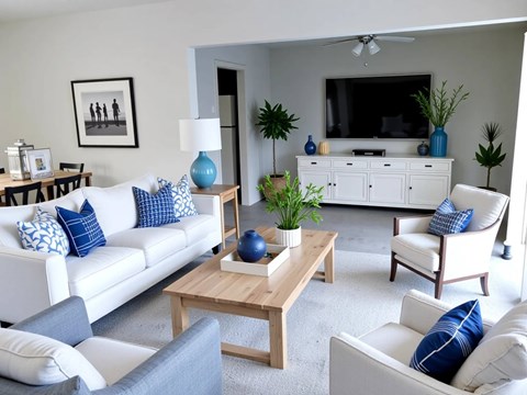 A living room with a white couch, a wooden coffee table, and a television on a cabinet.