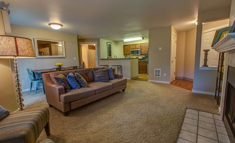 a living room with a couch and a kitchen