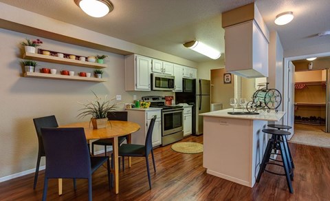 a kitchen and dining room with a table and chairs