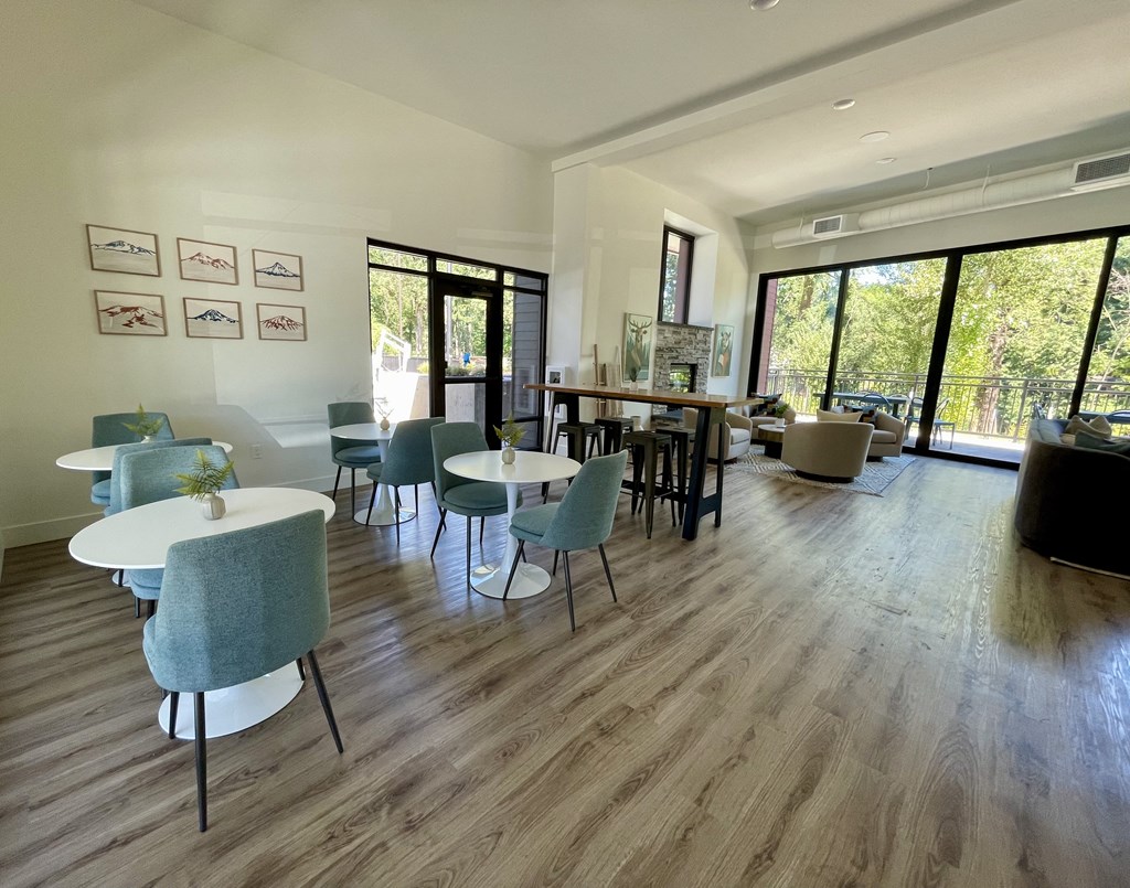 a room with hardwood floors and large windows