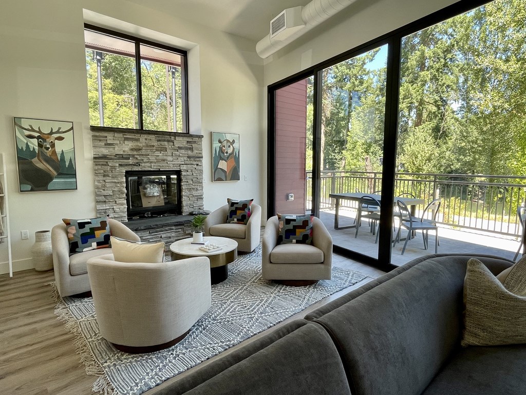 a living room with couches chairs and a fireplace