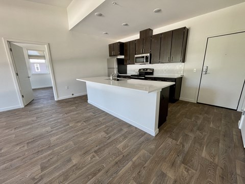 a view of a kitchen with a large island in the middle