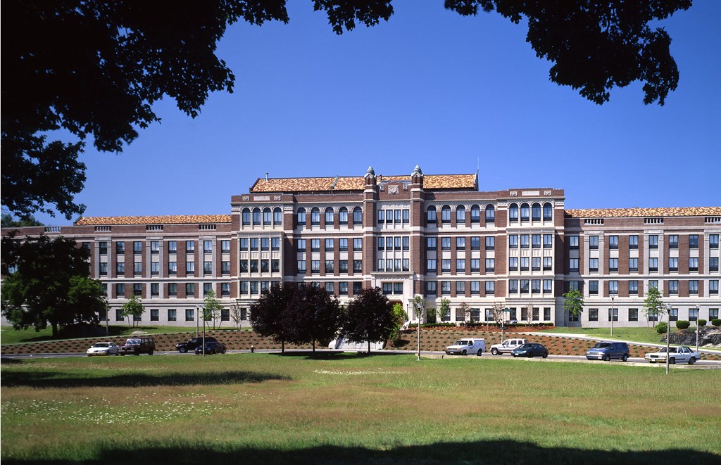 a large building with cars parked in front of it