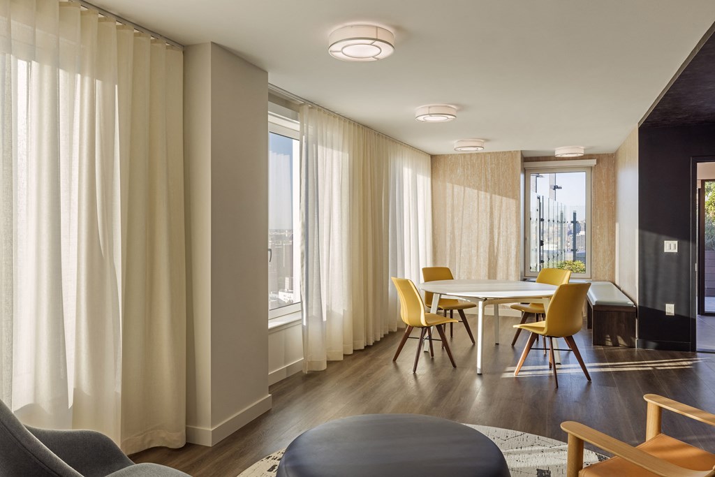 a dining room with a table and chairs and a large window