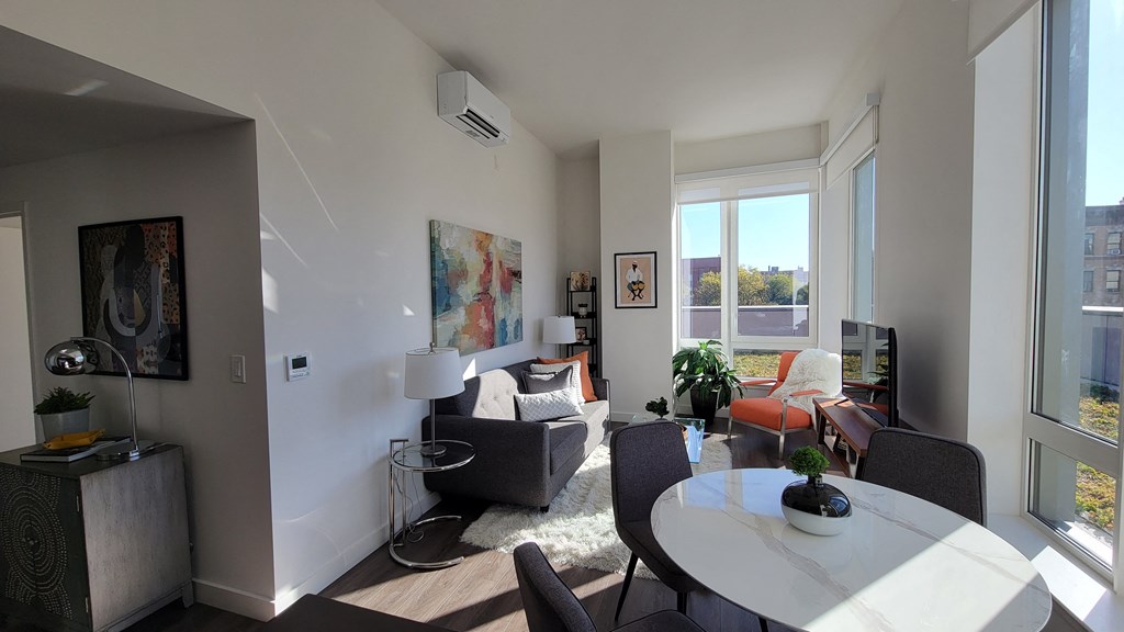 a living room with a table and a couch and a window