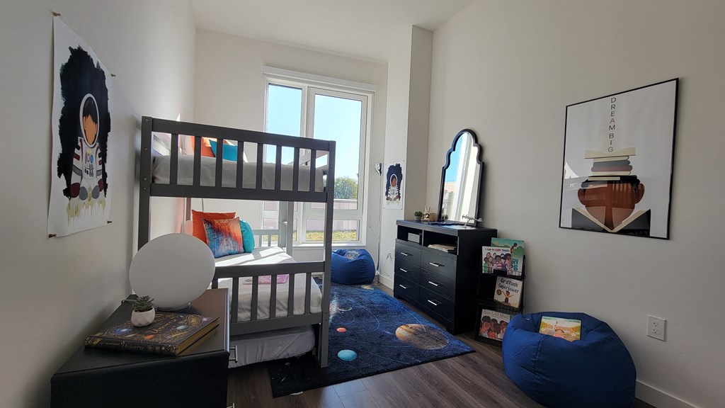 a childrens bedroom with bunk beds and a window