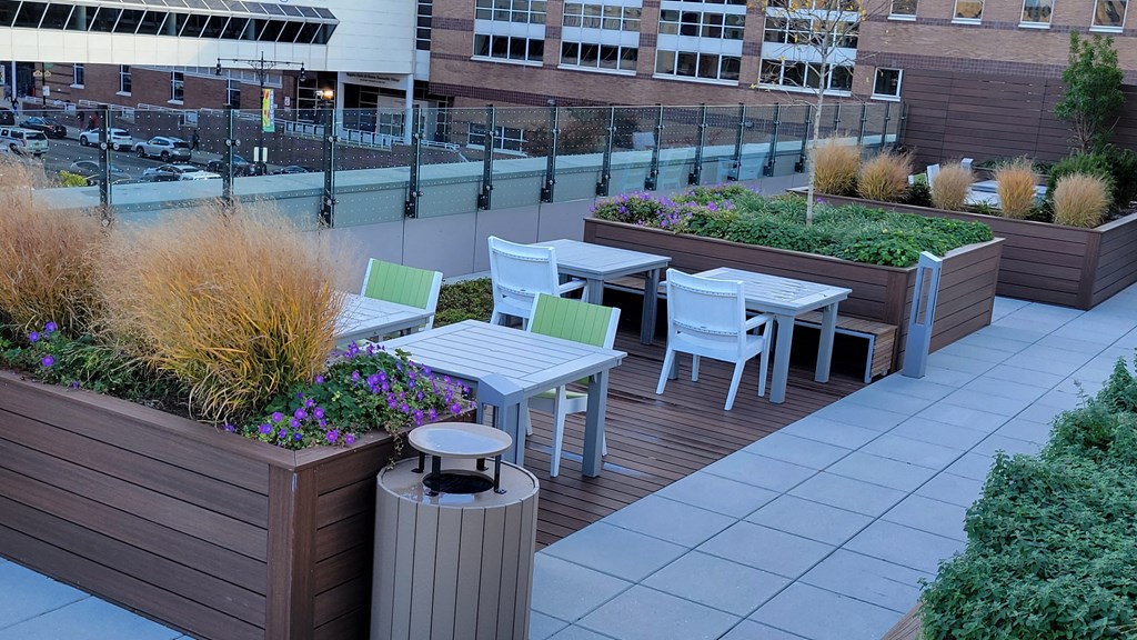 a patio with tables and chairs on a roof