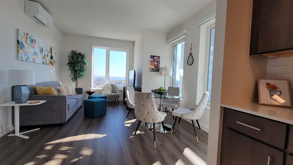 a living room and dining room with a table and chairs