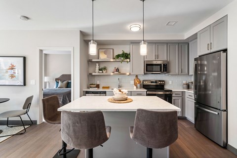 A modern kitchen with a dining table and chairs.
