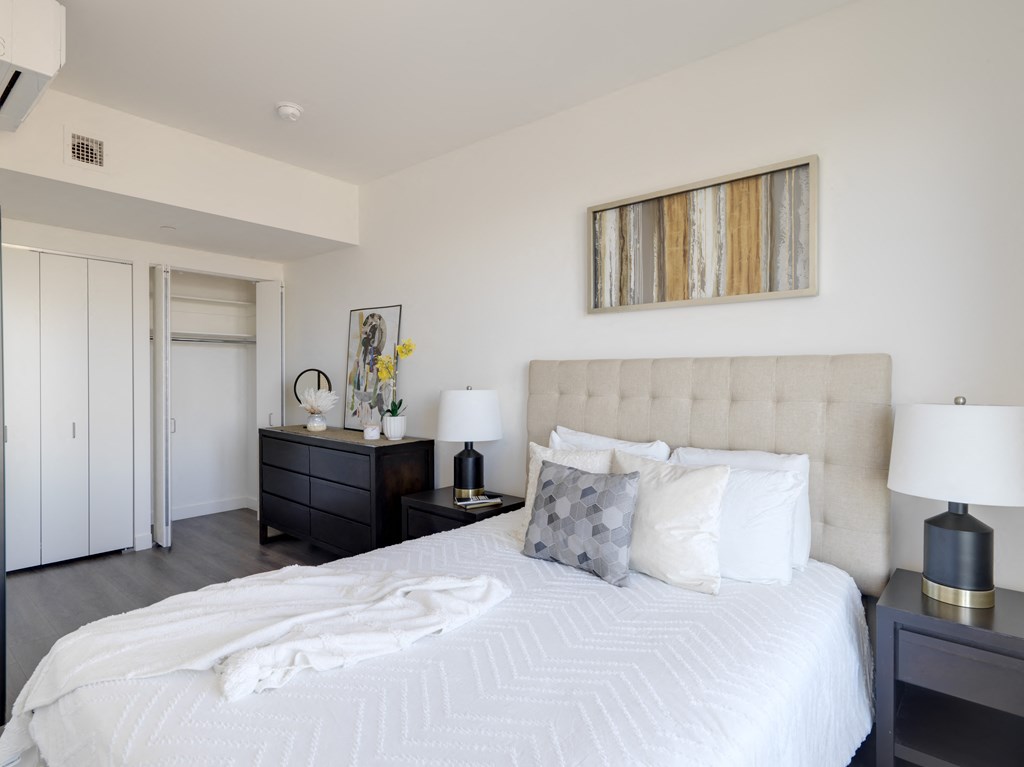 a bedroom with a bed and a dresser and a window