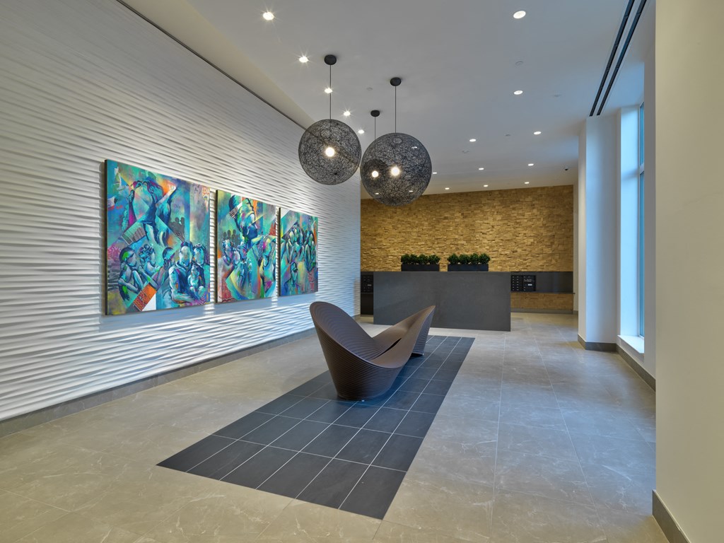 a lobby with a seating area and a painting on the wall