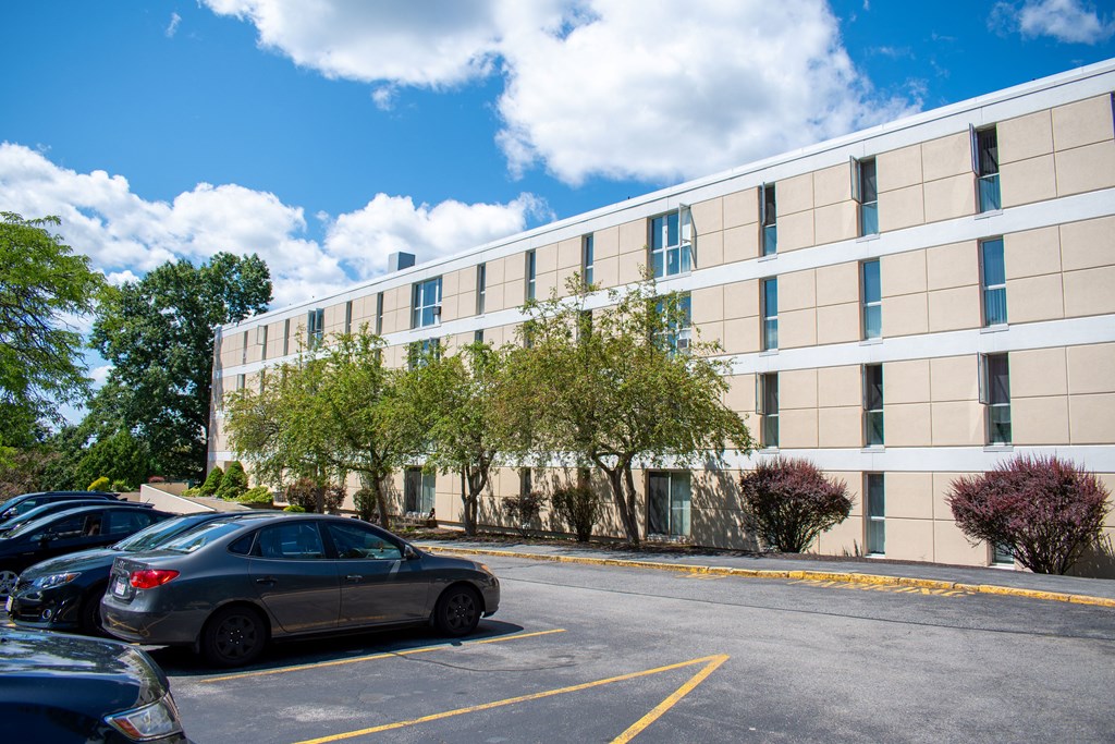 an office building with a parking lot in front of it