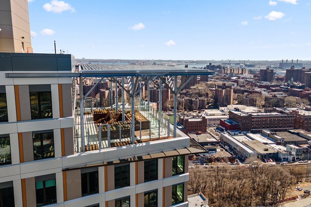 an aerial view of a building with a balcony overlooking a city