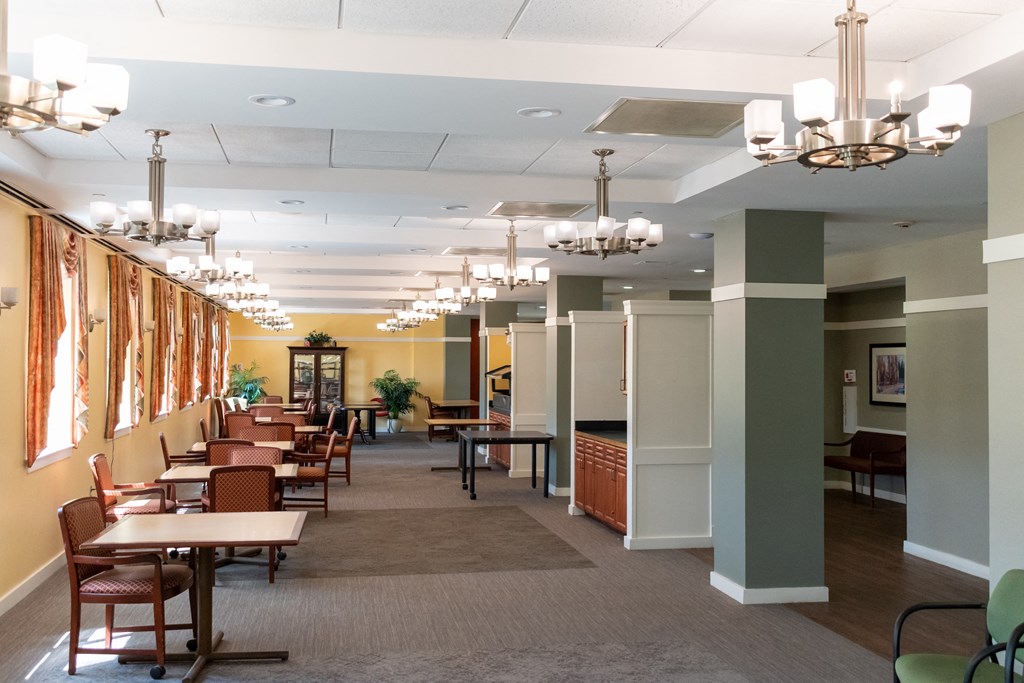a dining room with chandeliers and tables and chairs